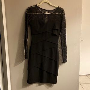 this is a black dress, long sleeve and patterns.